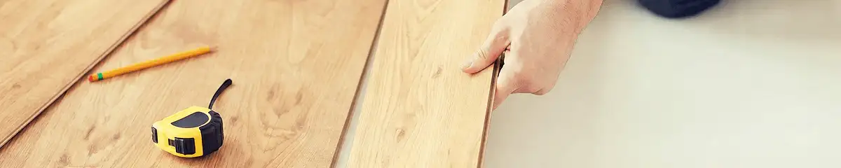 A professional installing wood flooring in Bloomington, IN