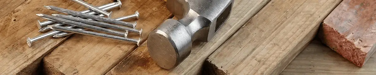 Hammer and nails on hardwood flooring boards in Bloomington, IN