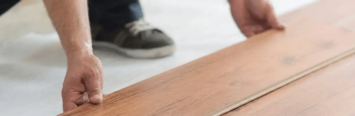 A professional installing laminate flooring in Bloomington, IN