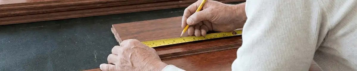 A professional installing wood flooring in Bloomington, IN